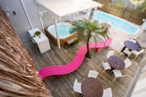 an overhead view of a deck with a hot tub and tables at Bossa Jurerê Hotel in Florianópolis