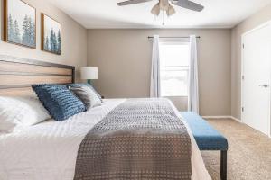 a bedroom with a large bed with a ceiling fan at 3BR Branson Condo PrimeLocation! in Branson +28 photos