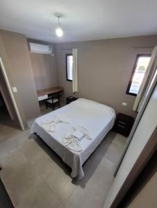 a bedroom with a bed with towels on it at ACHALAY, Alquileres temporarios Catamarca. DPTOS CENTRICOS HERMOSOS in San Fernando del Valle de Catamarca