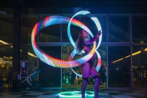 a woman is holding a hula hoop at night at Lüks Daire 5 YILDIZLI OTELDE in Kuşadası