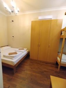 a bedroom with two beds and a bunk bed at Belokorichi in Kyiv