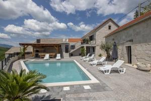 a villa with a swimming pool and a house at Villa Marija in Krstatice
