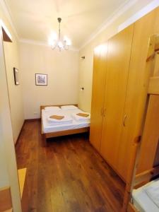 a small room with a bed and wooden floors at Belokorichi in Kyiv