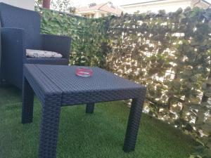 a blue table and a chair next to a fence at Appartamento Mari Mari in Casale Monferrato