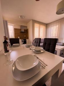 a dining table with plates and wine glasses on it at Elegant Escape apartment I - City Centre in Bratislava