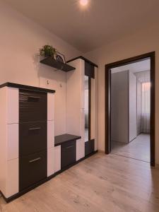 an empty room with a cabinet and a door at Elegant Escape apartment I - City Centre in Bratislava