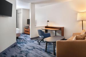 a hotel room with a couch and a table at Fairfield Inn & Suites by Marriott Jacksonville in Jacksonville