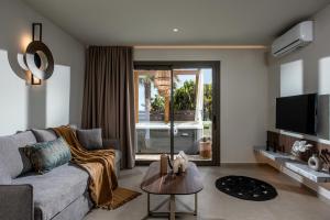 a living room with a couch and a table at Everest Apartments and Suites in Stalís