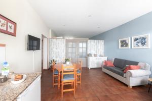 a living room with a couch and a table at Apartamentos turísticos La Flor in Muros de Nalón