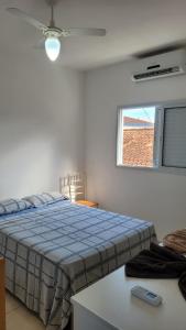 a bedroom with a blue bed and a window at Sol Mar Pousada in Praia Grande