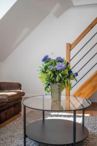 un vaso di fiori su un tavolo di vetro in soggiorno di M&F Sweet In Black a Vilvoorde
