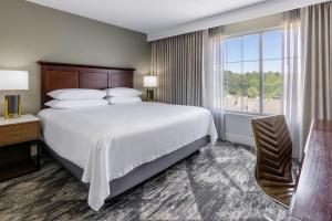 a hotel room with a bed and a large window at Sheraton Atlanta Perimeter North in Atlanta