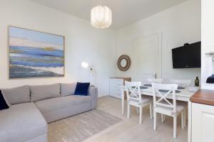 a living room with a couch and a table at Apartment with patio 50m from the beach and Lungomare in Opatija