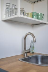 a kitchen sink with a bottle of water next to it at M&F Sweet In Grey in Vilvoorde