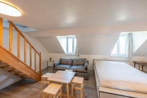 ein Wohnzimmer mit einem Bett und einem Sofa in der Unterkunft M&F Sweet In Grey in Vilvoorde
