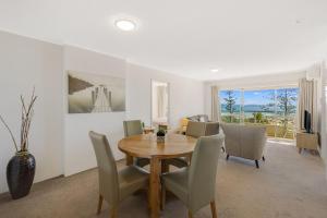 a dining room with a wooden table and chairs at Kooringal Unit 16 in Gold Coast
