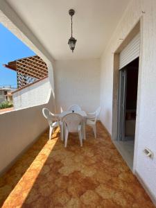 a white table and chairs on a balcony at Lu Jentu in Torre Ovo