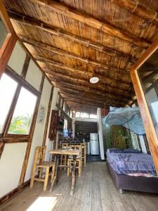 a room with a table and chairs and a bed at Mancora Sunset House in Máncora