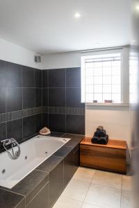 a bathroom with a bath tub and a window at Avignon centre, Maison avec Piscine in Avignon +20 photos