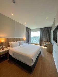 a hotel room with a large bed and a large window at Wyndham Garden Cartagena in Cartagena de Indias