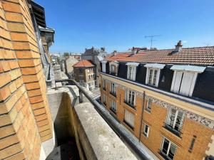 a view of a city from a balcony with buildings at Hincmar de YourHostHelper in Reims