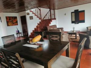 a dining room with a wooden table and chairs at Chalet_Laguna_Azul in Aquitania