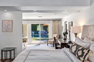a bedroom with a bed and a living room at Lola Vista in Palm Springs