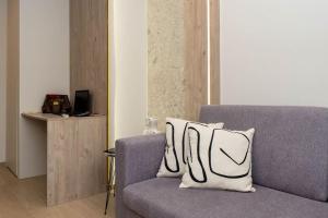 um sofá com duas almofadas num quarto em 8 Blocks Apartments 4A em Alexandroúpolis