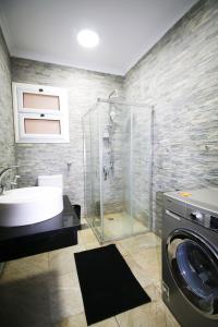 a bathroom with a sink and a washing machine at Apple Candy property in Madinaty in Madīnat ash Shurūq