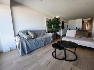 sala de estar con sofá y mesa en Appart Noah SeaFront en Knokke-Heist