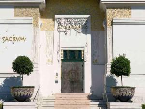 a front door of a white building with two plants at Hotel Mercure Wien City in Vienna
