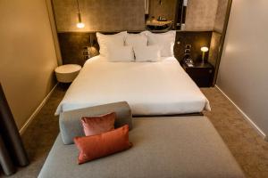 a bedroom with a large white bed with two pillows at Best Western Premier BHR Treviso Hotel in Quinto di Treviso