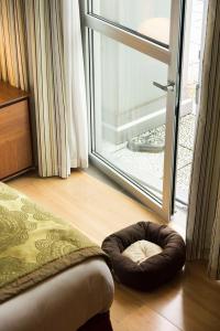 a dog bed sitting on the floor next to a door at Best Western Premier BHR Treviso Hotel in Quinto di Treviso