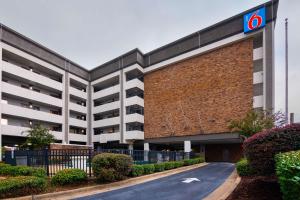 a building with a parking lot in front of it at Motel 6-Columbus, GA - Downtown in Columbus