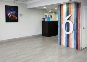a room with a large sign on a wall at Motel 6-Columbus, GA - Downtown in Columbus