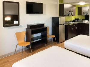 a small room with a bed and a kitchen at Motel 6-Columbus, GA - Downtown in Columbus