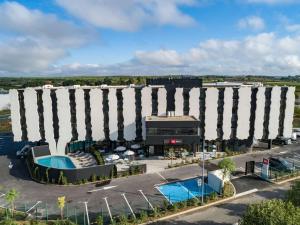 an overhead view of a large building with a pool at Ibis Lunel Petite Camargue in Lunel