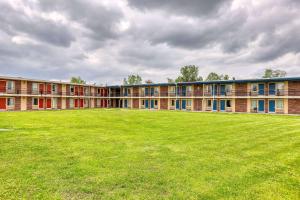 a large grassy field in front of a building at Suburban Studios Neenah-Appleton in Neenah