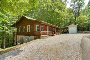 a large house with a driveway in the woods at Byrdstown Cabin - with Fire Pit, Near Marina and Lake! in Frogue