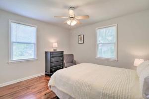 a bedroom with a bed and a ceiling fan at Pool home sleeps 6 with large fenced yard in Jacksonville +16 photos
