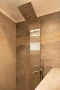 a shower with a glass door in a bathroom at The 50/50 Luxury Apartments in Sidari
