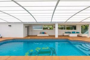 a swimming pool in a house with a ceiling at Ohana Luxury Villa with Heated Pool in Málaga