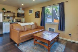 a living room with a couch and a coffee table at Cozy Coeur dAlene Studio, Walk to Downtown and Lake in Coeur d'Alene