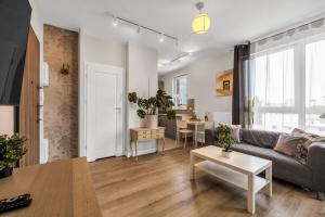 a living room with a couch and a table at Studio Groszowicka AC SWPS in Warsaw