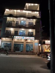 a large building with lights on the side of it at F R Darya e Swat Hotel in Swat