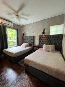 a bedroom with two beds and a ceiling at Areli in Playa del Carmen
