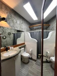a bathroom with a sink and a toilet and a shower at Areli in Playa del Carmen