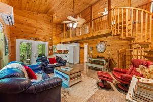 a living room with couches and chairs in a cabin at Serenity Escape Treehouse on 14 acres near Little River Canyon in Fort Payne