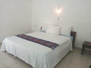 Postel nebo postele na pokoji v ubytování Bukit Garden Gili Trawangan