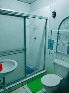 a bathroom with a shower and a toilet and a sink at Hostal Leyendas in León +102 photos